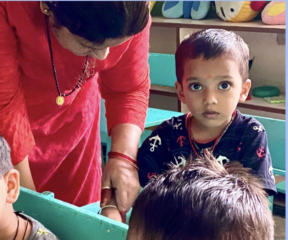 Pre-Nursery child learning with teacher support